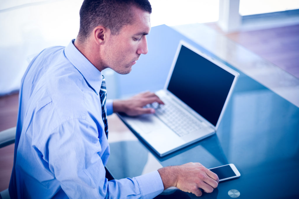 Businessman Working At His Desk In His Office - Grupo Contabiliza